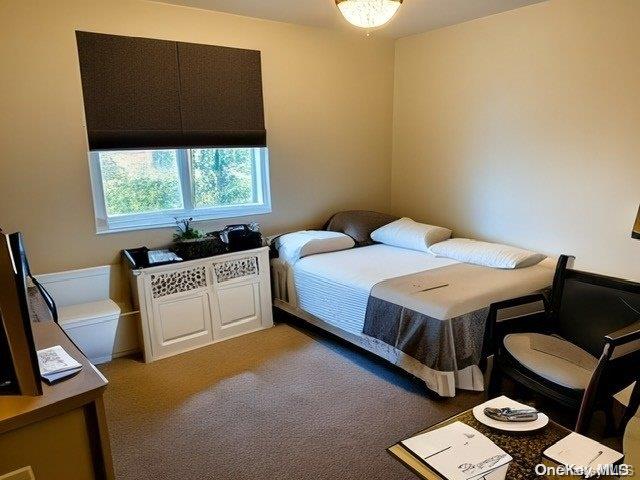 6748 Springfield Boulevard, Unit 1 Queens, NY 11364 - Photo 3 of 7 a bedroom with a bed and a window