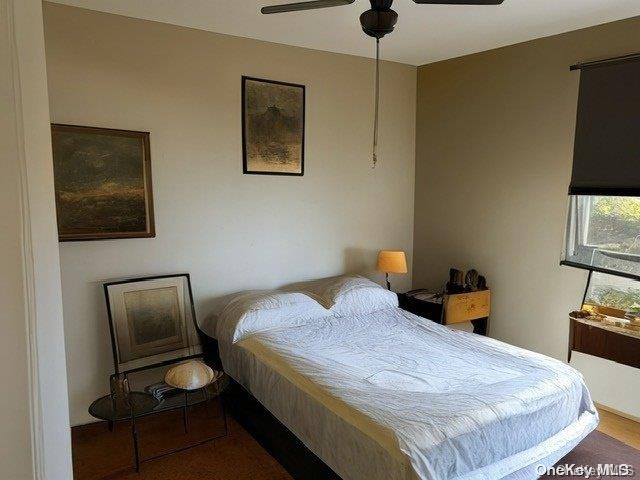 6748 Springfield Boulevard, Unit 1 Queens, NY 11364 - Photo 4 of 7 a bedroom with a bed and wooden floor