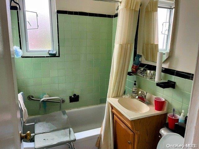 6748 Springfield Boulevard, Unit 1 Queens, NY 11364 - Photo 7 of 7 a bathroom with a sink toilet and a mirror