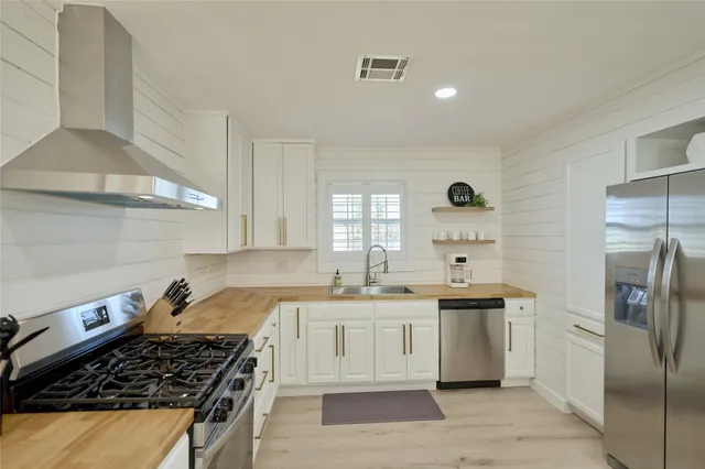 a kitchen with a sink stove and refrigerator