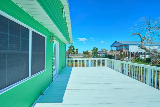 a view of a balcony with yard