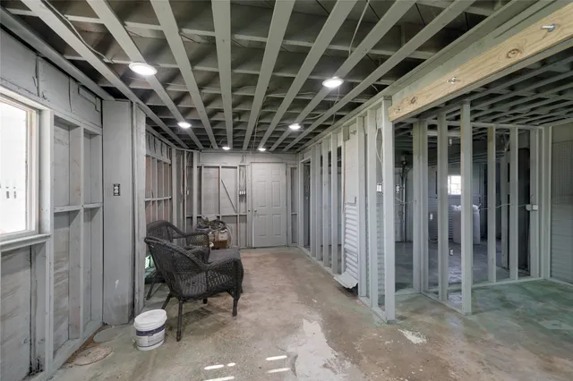a view of an empty room with wooden floor and a glass door
