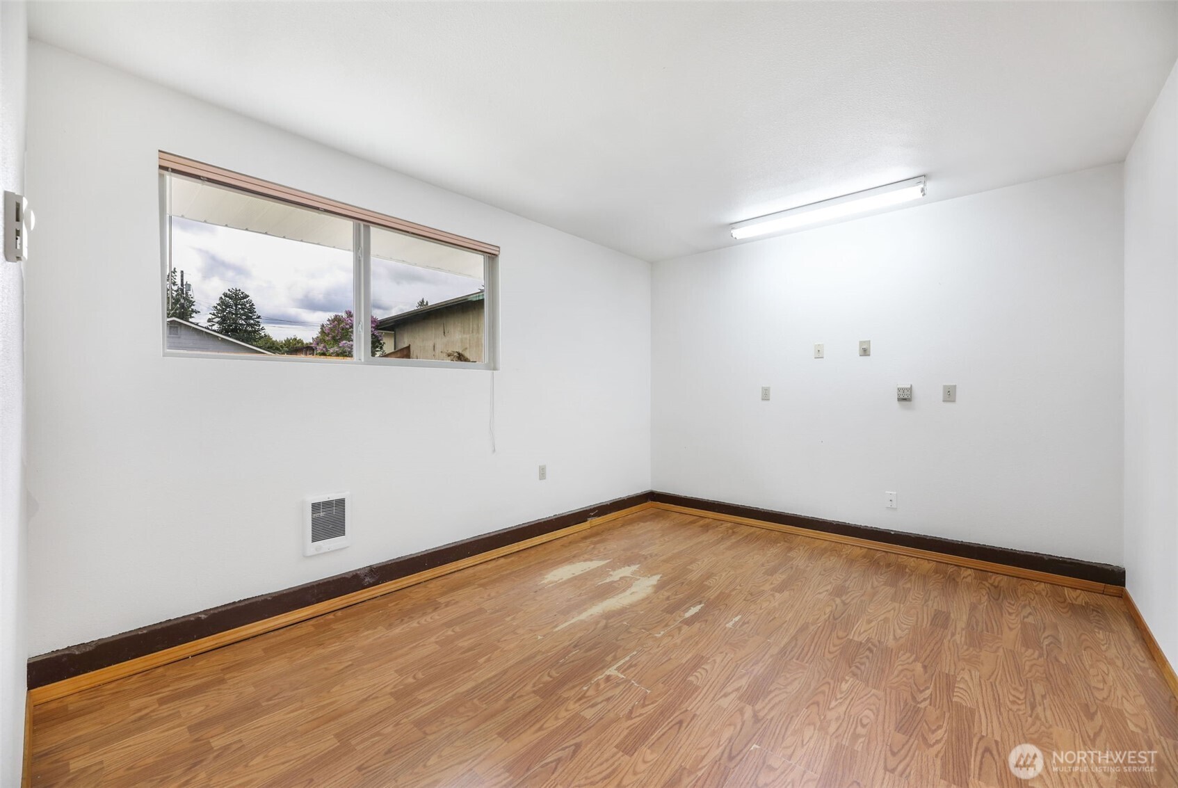 7304 Beverly Boulevard Everett, WA 98203 - Photo 26 of 38 a view of an empty room with wooden floor and a window