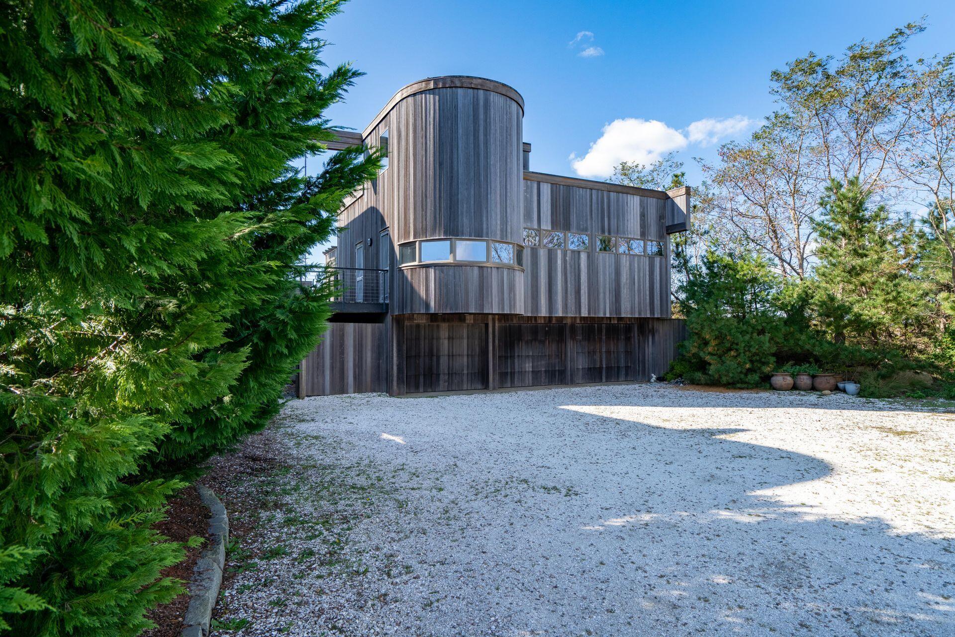 6 Payomet Lane Truro, MA 02666 - Photo 16 of 52 a view of a house with wooden fence next to a yard