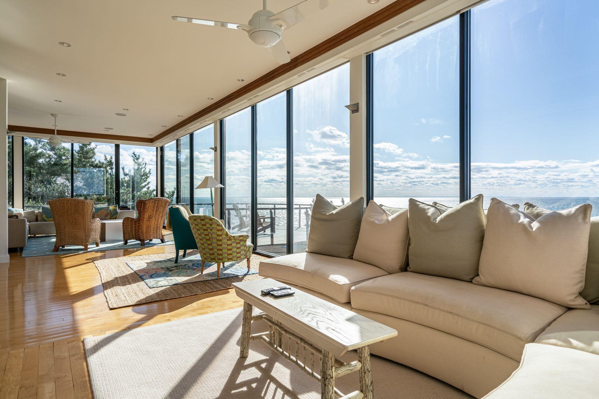 6 Payomet Lane Truro, MA 02666 - Photo 19 of 52 a living room with furniture and floor to ceiling windows