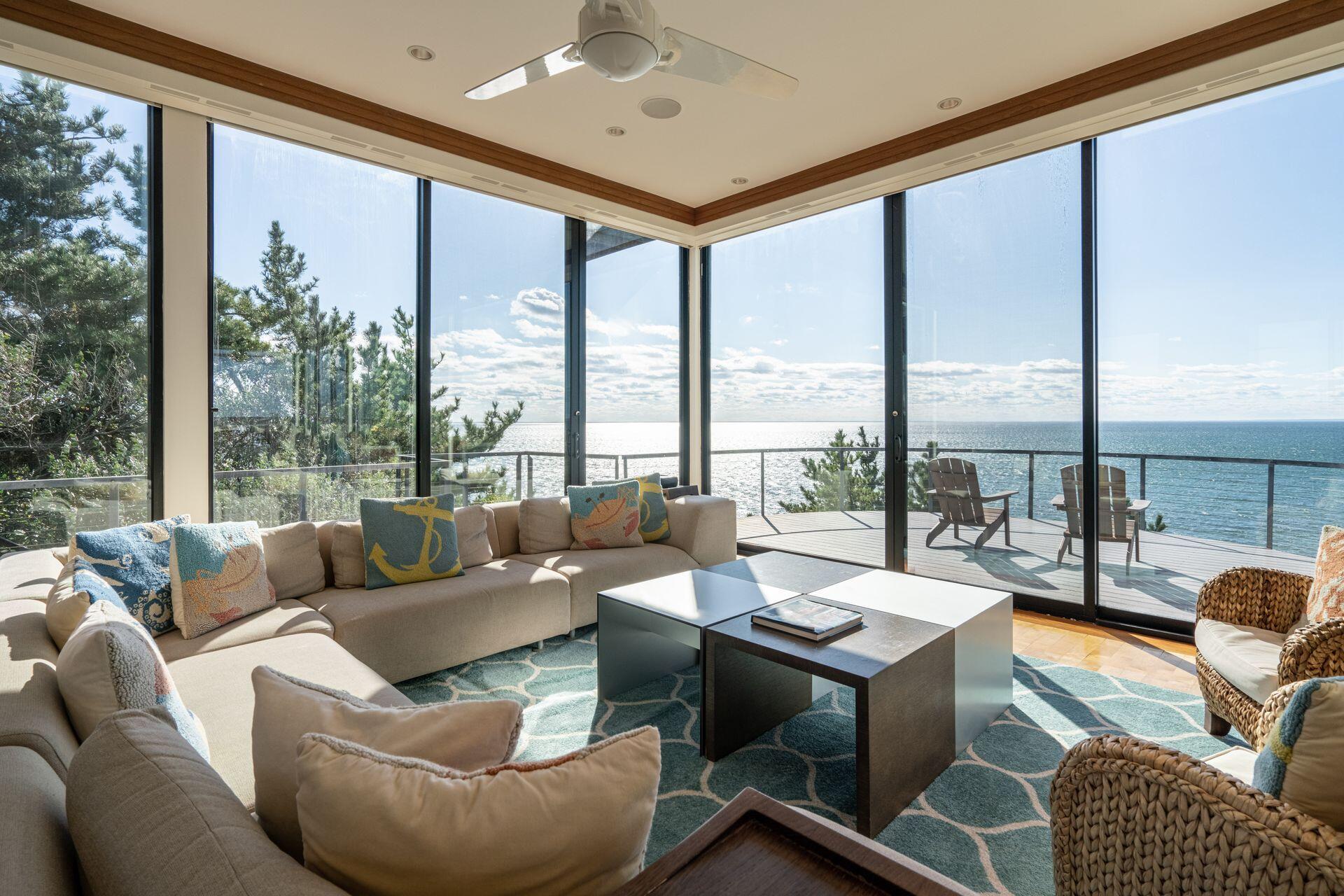 6 Payomet Lane Truro, MA 02666 - Photo 20 of 52 a living room with furniture and floor to ceiling windows