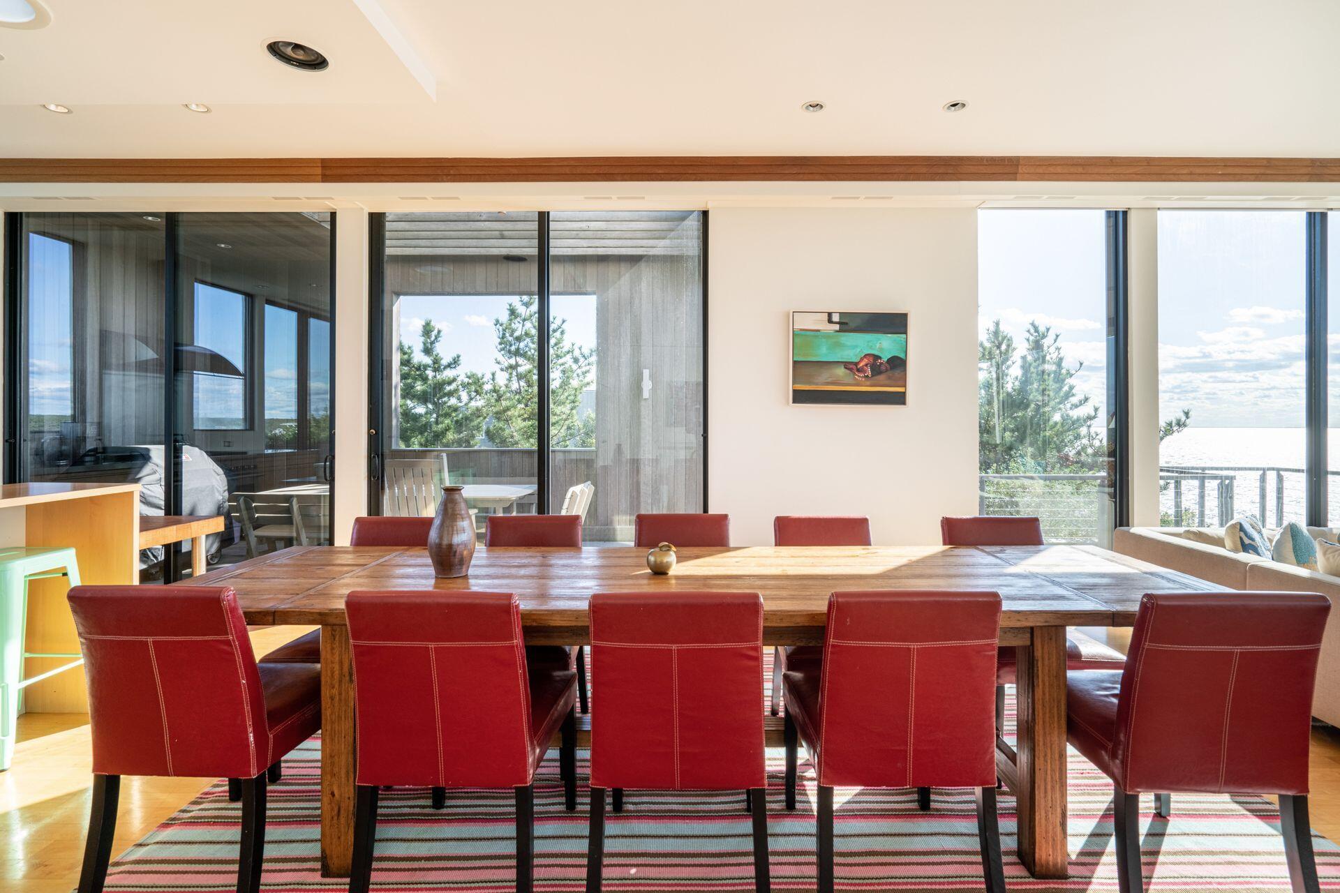 6 Payomet Lane Truro, MA 02666 - Photo 24 of 52 a view of a dining room with furniture large windows and wooden floor