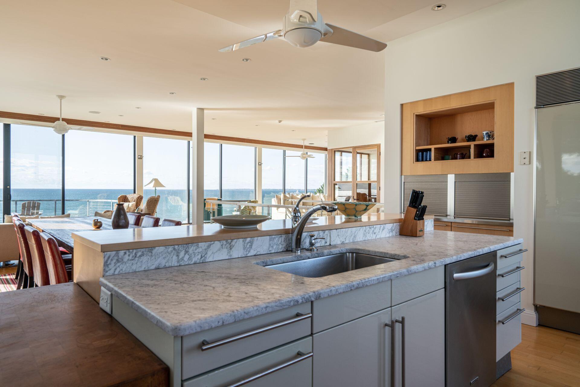 6 Payomet Lane Truro, MA 02666 - Photo 26 of 52 a view of kitchen island a sink and living room with a large window
