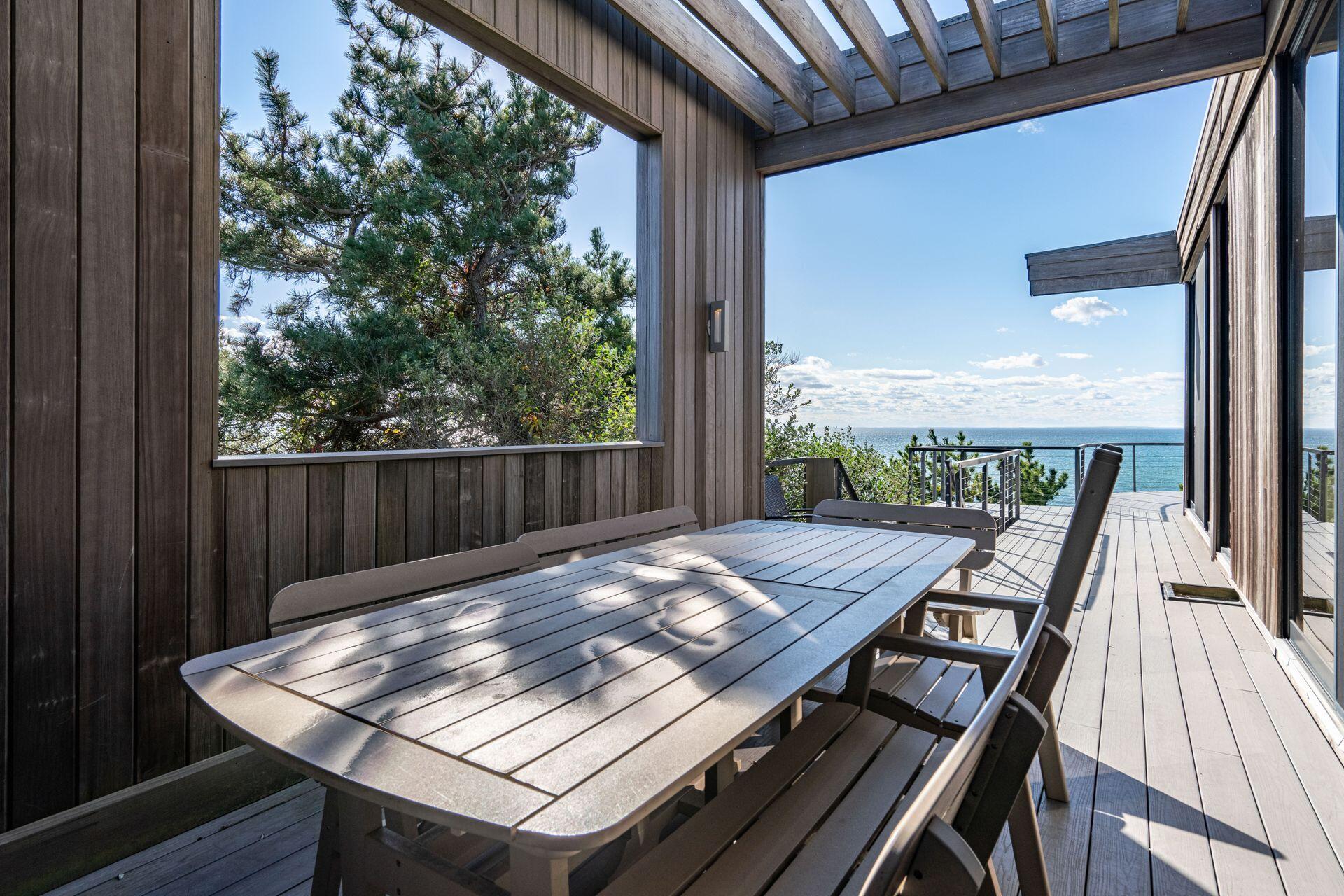 6 Payomet Lane Truro, MA 02666 - Photo 27 of 52 a view of a tables and chair in the balcony