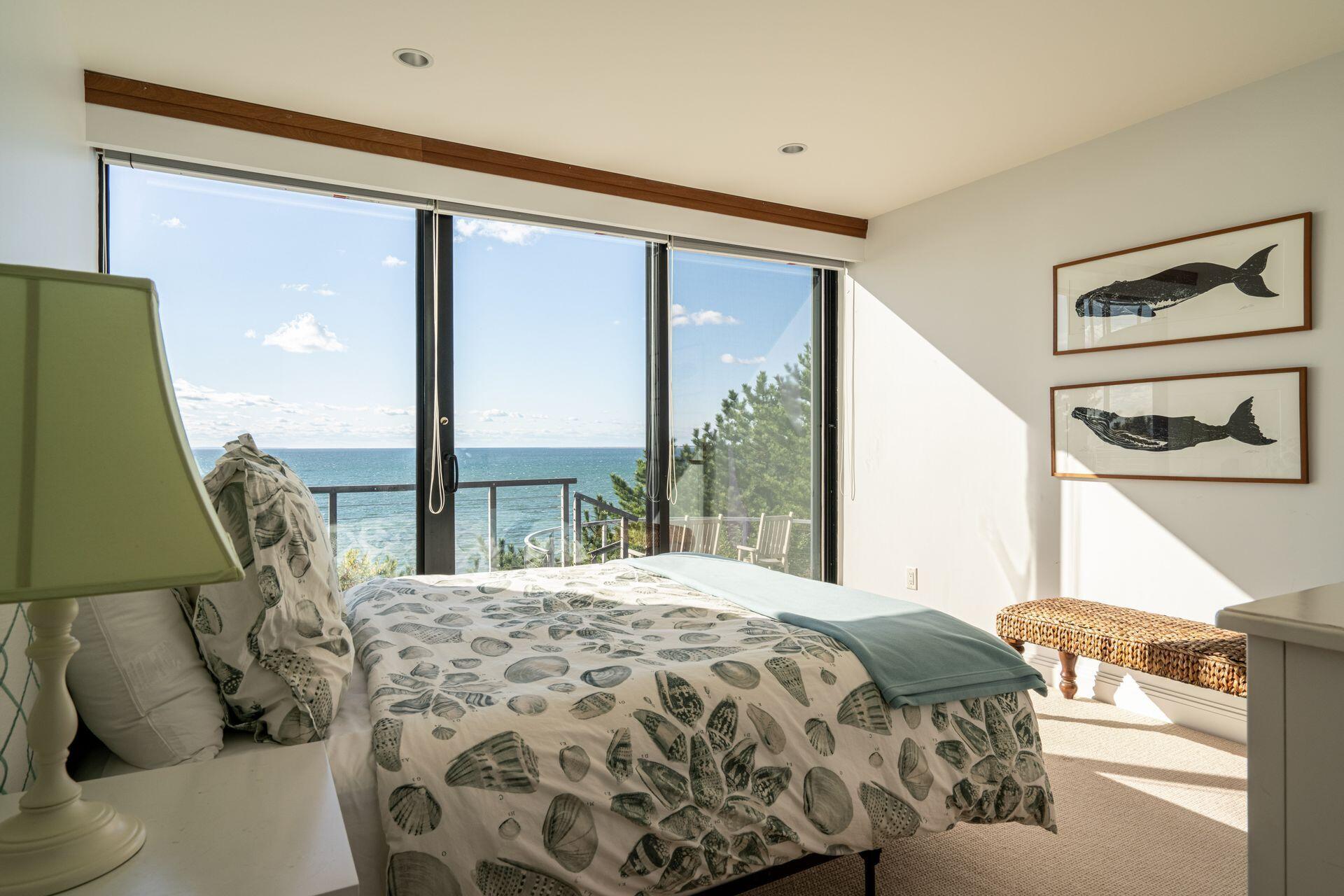 6 Payomet Lane Truro, MA 02666 - Photo 38 of 52 a bedroom with a large bed and a large window with outer view