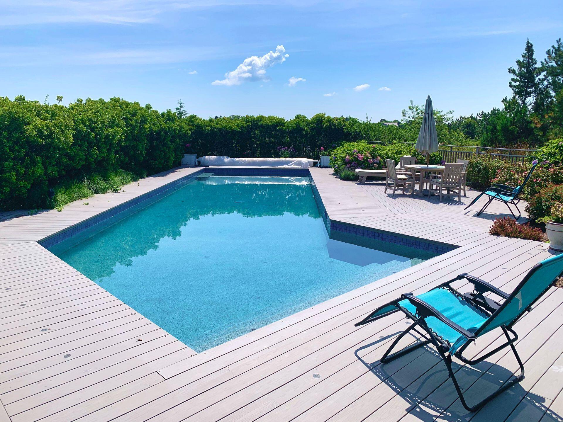 6 Payomet Lane Truro, MA 02666 - Photo 52 of 52 a view of a chairs and table on the wooden deck with a backyard
