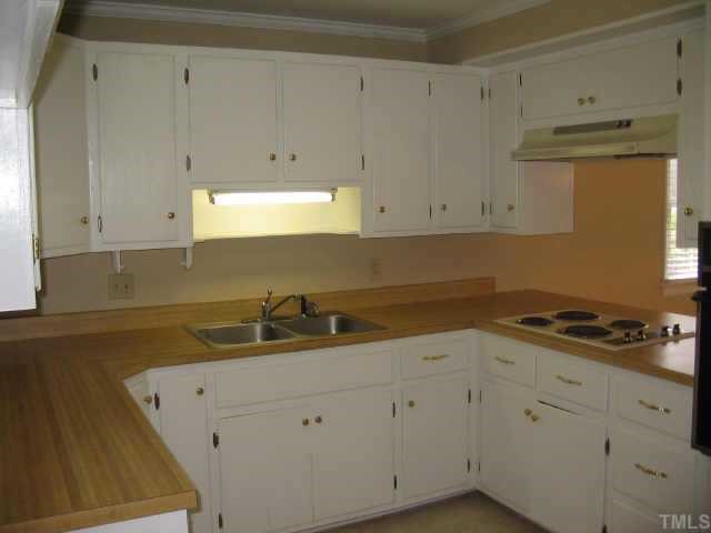 3046 Farrior Road Raleigh, NC 27607 - Photo 8 of 10 a kitchen with white cabinets and a stove