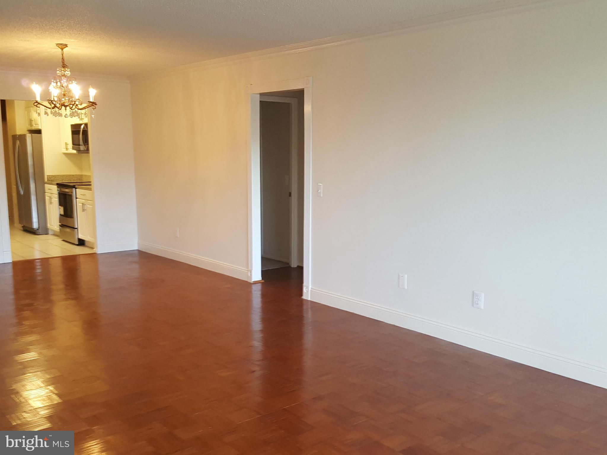 6101 Edsall Road, Unit 1506 Alexandria, VA 22304 - Photo 14 of 26 a view of a livingroom with wooden floor and a large window