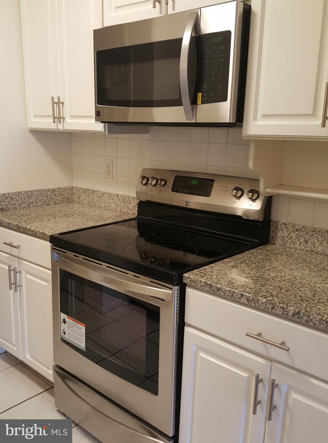 6101 Edsall Road, Unit 1506 Alexandria, VA 22304 - Photo 7 of 26 a stove top oven sitting inside of a kitchen