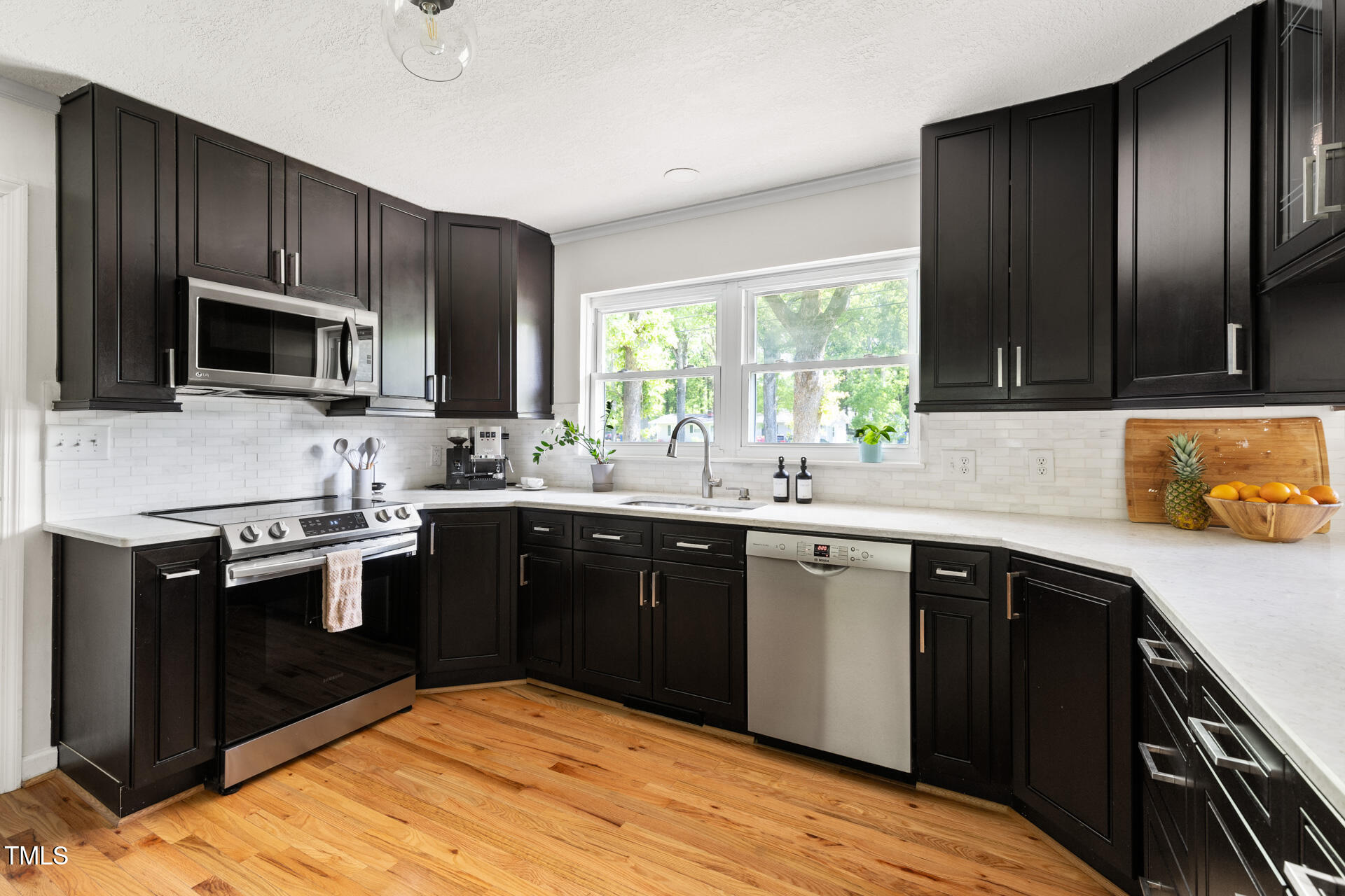 2702 Richwood Road Durham, NC 27705 - Photo 22 of 47 a kitchen with a sink stove and microwave