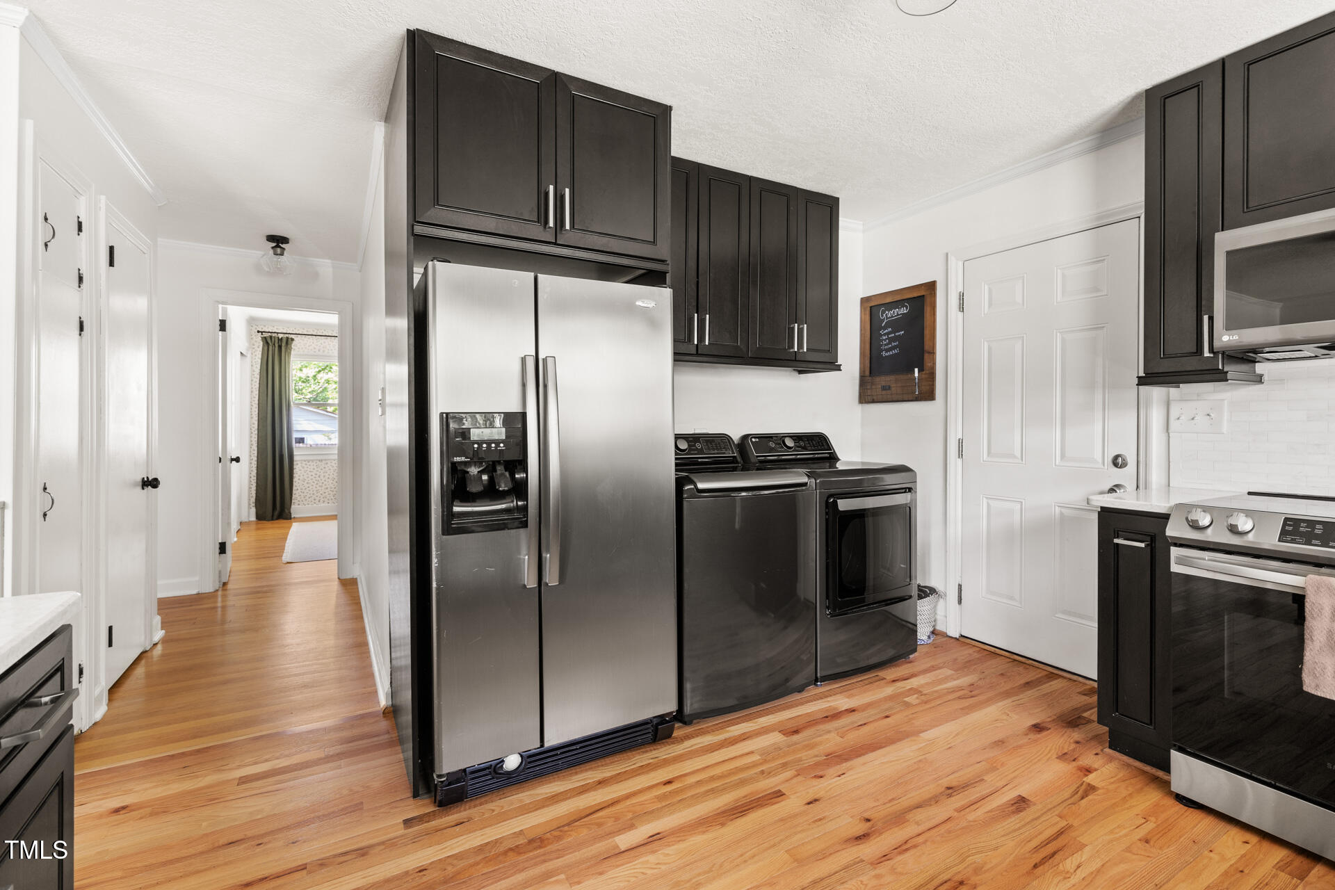 2702 Richwood Road Durham, NC 27705 - Photo 26 of 47 a kitchen with stainless steel appliances and wooden floor