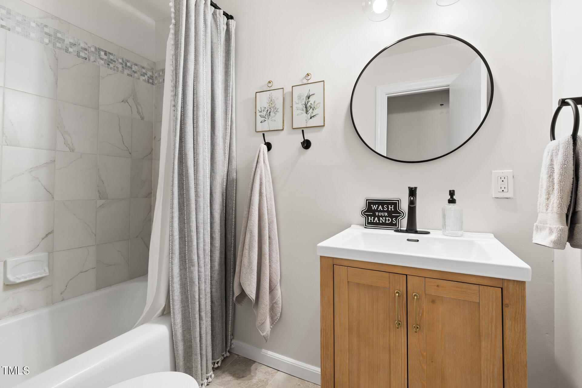 2702 Richwood Road Durham, NC 27705 - Photo 39 of 47 a bathroom with a sink a vanity and a mirror