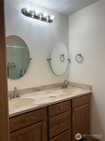 a bathroom with a double vanity sink and a mirror