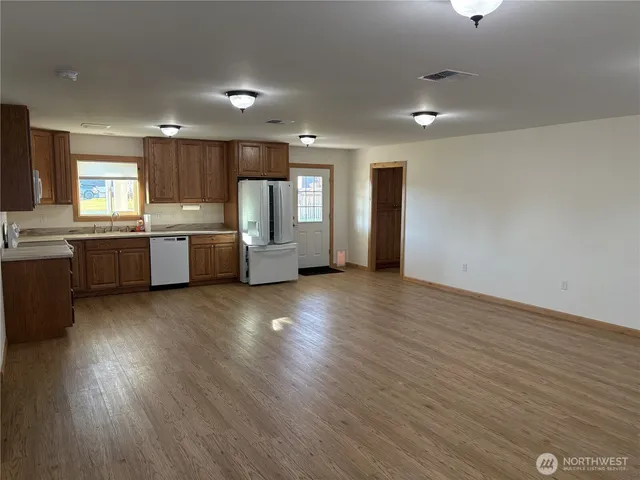 a view of kitchen with granite countertop cabinets and wooden floor