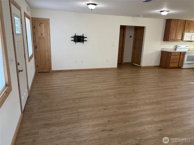 a view of a kitchen with wooden floor