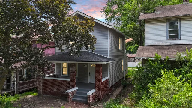 a front view of a house with a garden