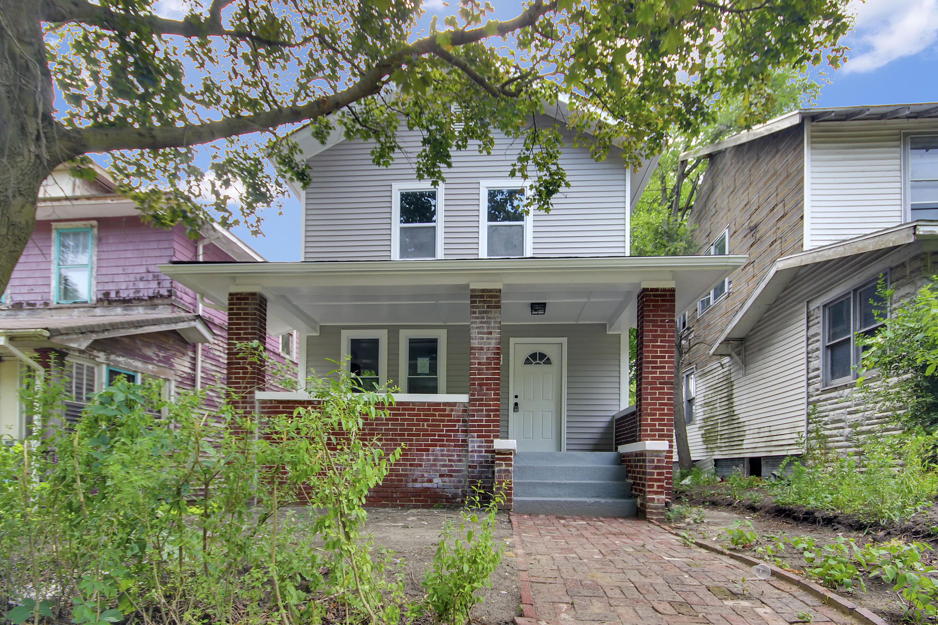 836 Fayette Street Gary, IN 46403 - Photo 2 of 16 a front view of a house with a garden