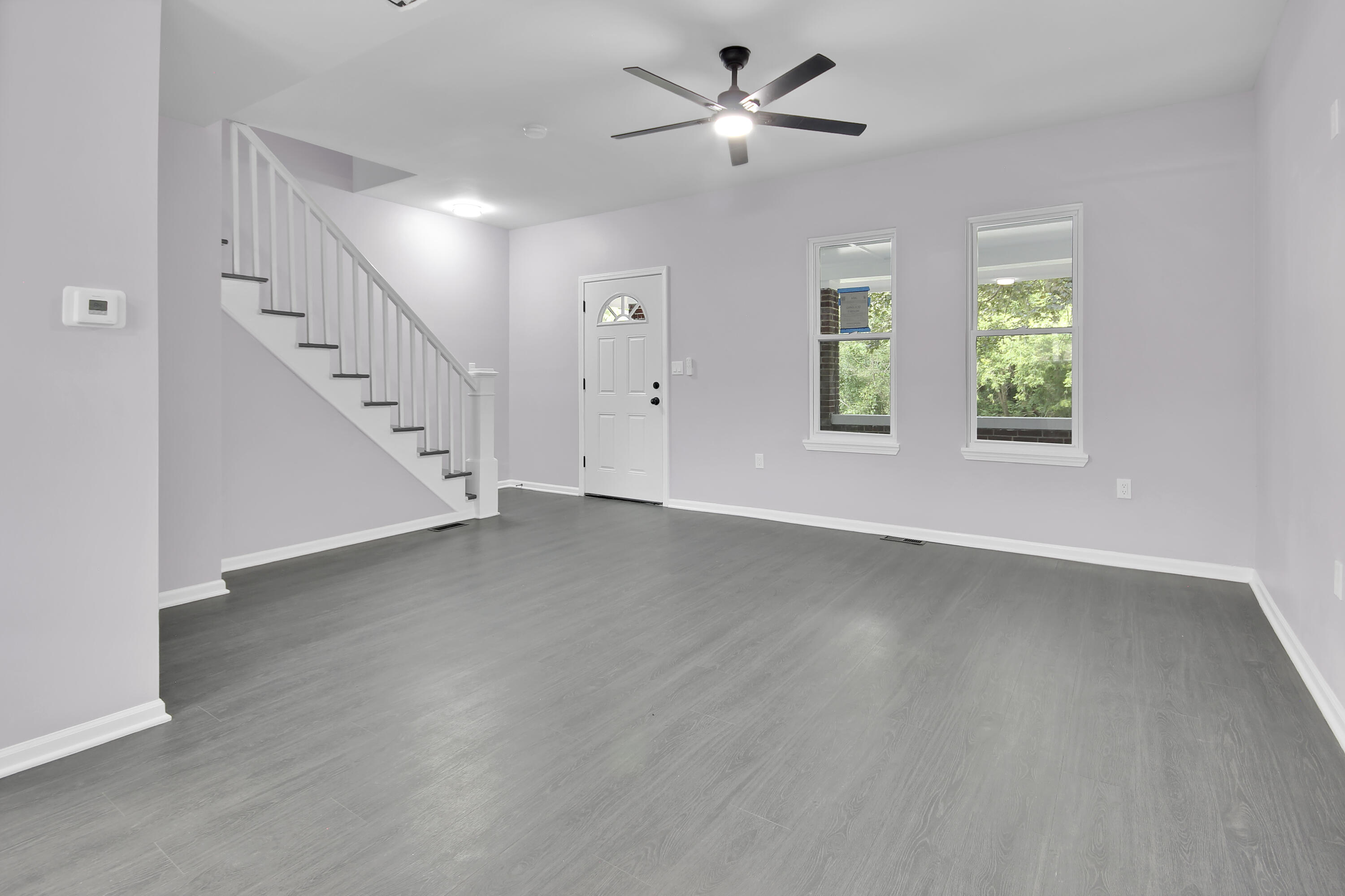 836 Fayette Street Gary, IN 46403 - Photo 5 of 16 a view of an empty room with wooden floor and a window