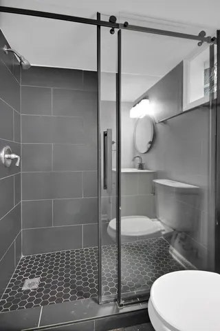 a bathroom with a toilet and a shower