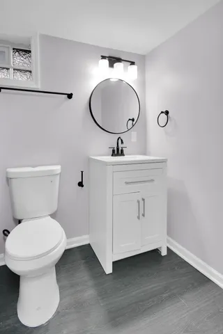 a bathroom with a toilet sink and mirror