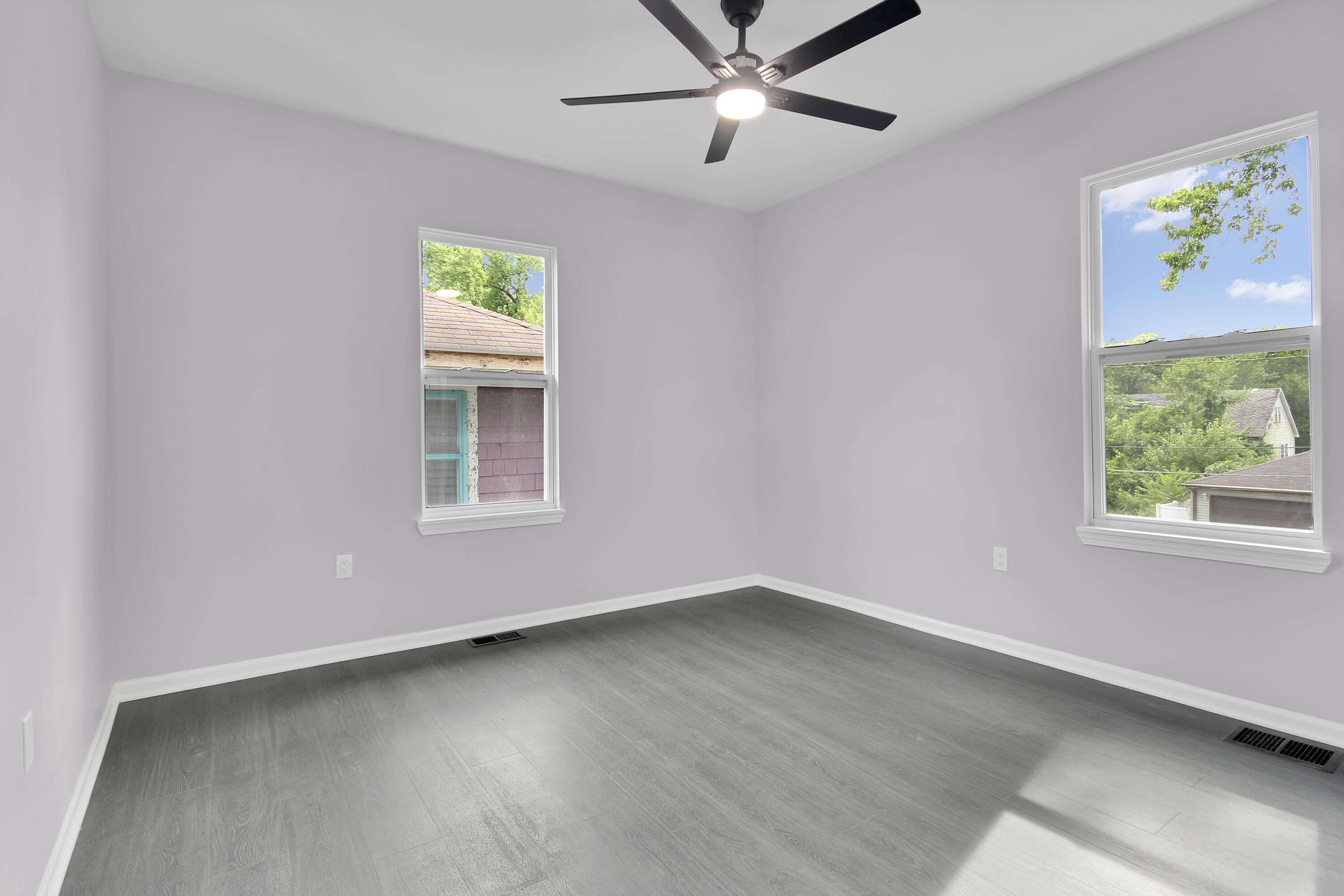 836 Fayette Street Gary, IN 46403 - Photo 10 of 16 a view of an empty room with a window and wooden floor