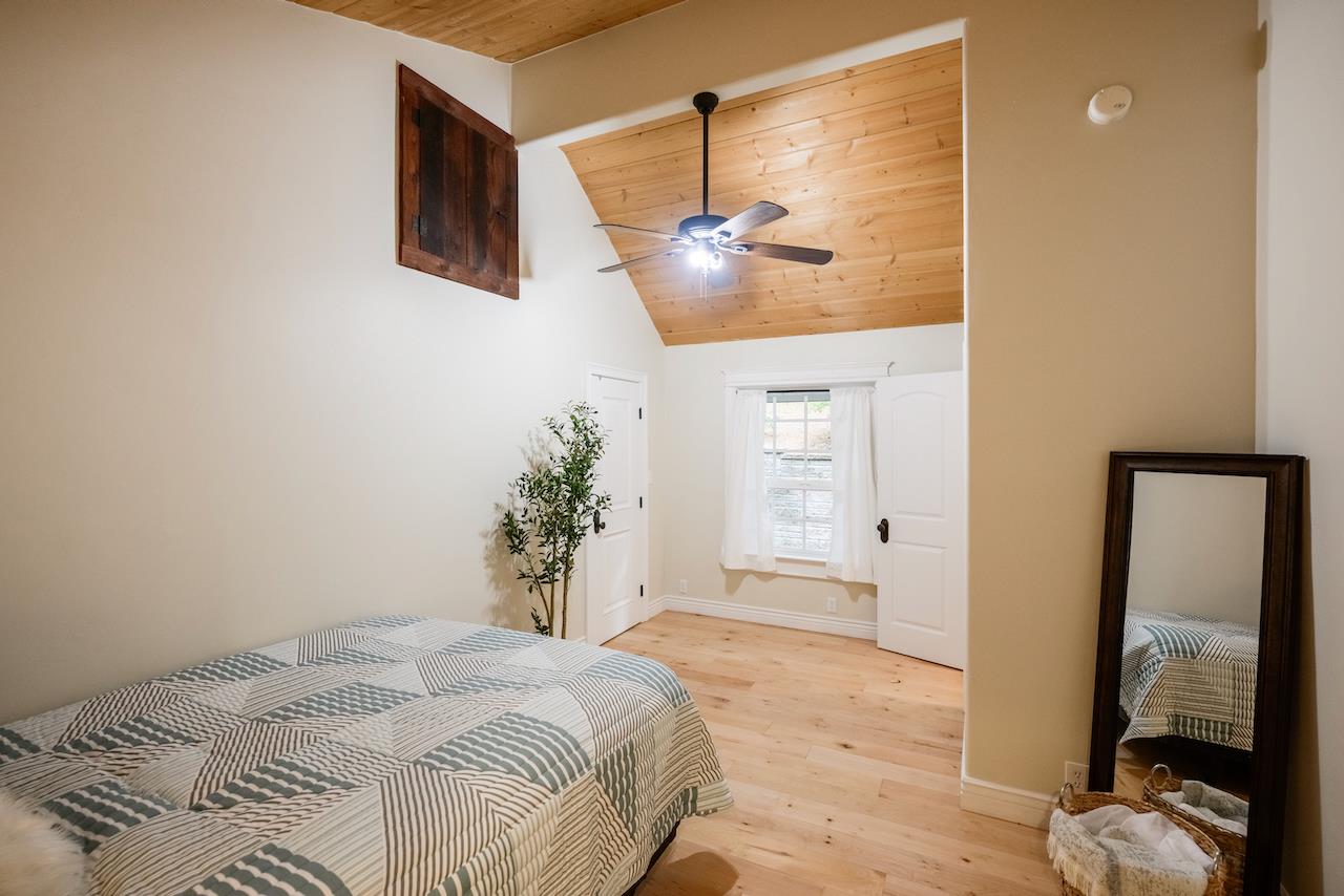 295 Jim's Road Ben Lomond, CA 95005 - Photo 75 of 139 a bedroom with a bed and a mirror