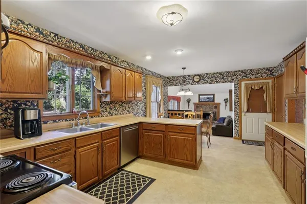 a kitchen with stainless steel appliances granite countertop a sink and cabinets