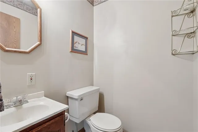 a white toilet sitting next to a bathroom sink