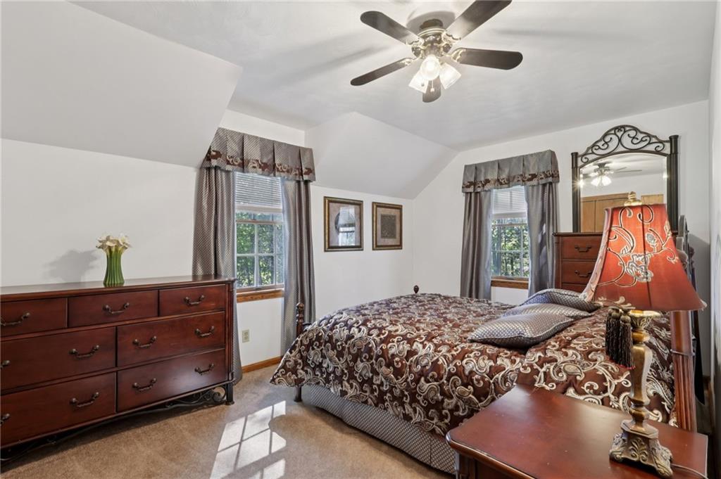 4302 Mitchell Road New Castle, PA 16105 - Photo 22 of 46 a bedroom with a bed and a chandelier