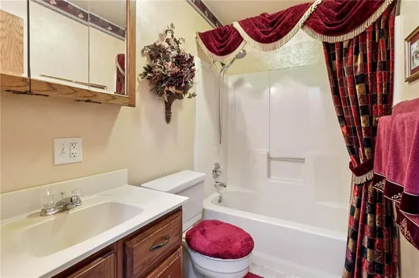 a bathroom with a sink a bath tub and a toilet