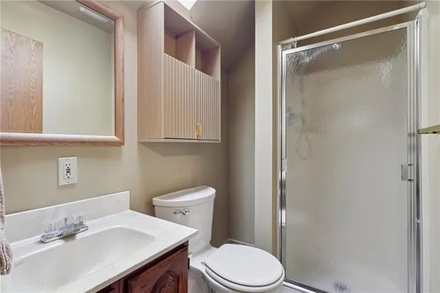 a bathroom with a sink vanity mirror and toilet