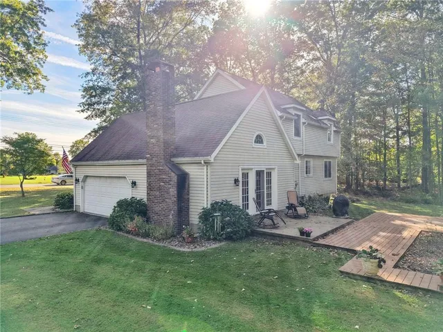 a front view of house with yard and outdoor seating