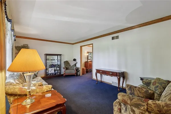 a living room with furniture and a lamp