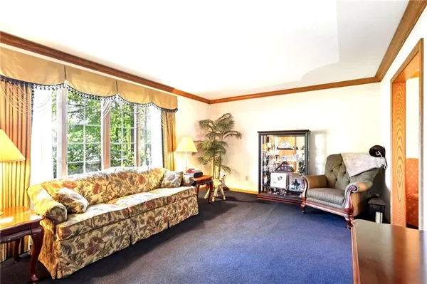 a bedroom with furniture and a large window