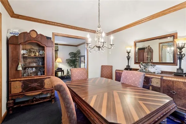 a view of a dining room with furniture and a chandelier
