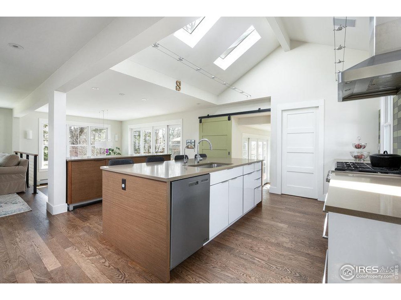 3221 8th Street Boulder, CO 80304 - Photo 12 of 40 a kitchen with stainless steel appliances granite countertop a sink a stove top oven a wooden floors