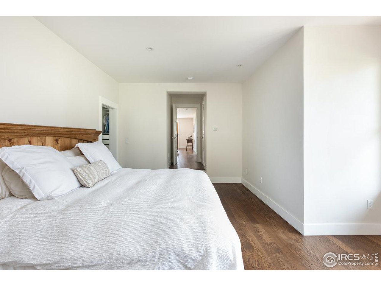 3221 8th Street Boulder, CO 80304 - Photo 17 of 40 a bedroom with a bed and a wooden floor
