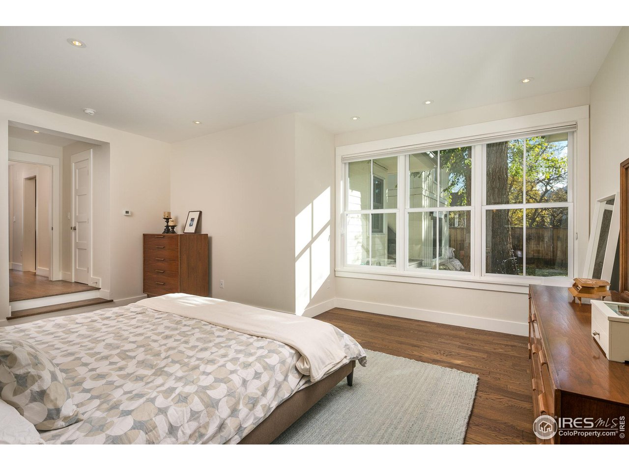 3221 8th Street Boulder, CO 80304 - Photo 18 of 40 a bedroom with a large bed and a large window