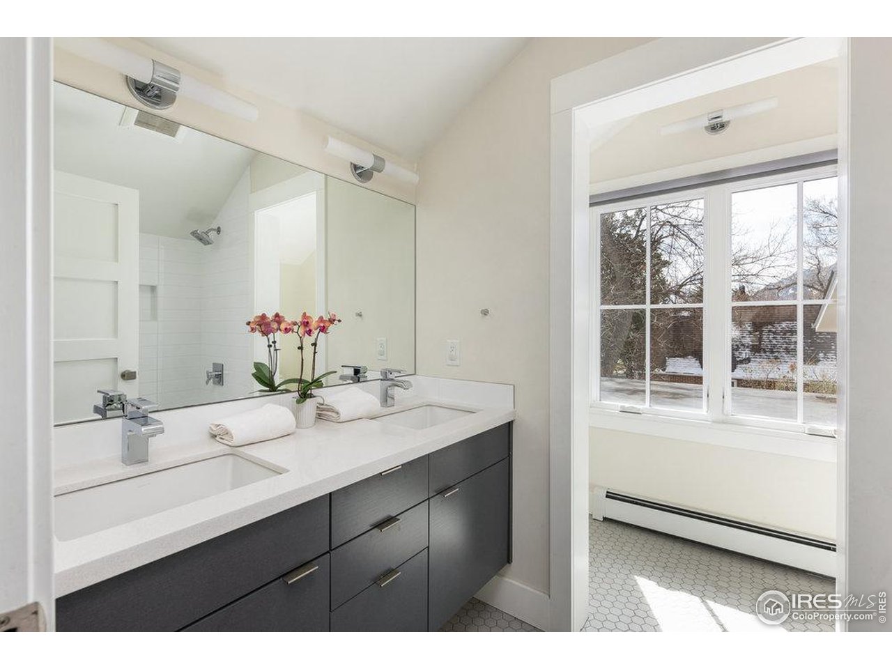 3221 8th Street Boulder, CO 80304 - Photo 29 of 40 a bathroom with a sink double vanity and a mirror