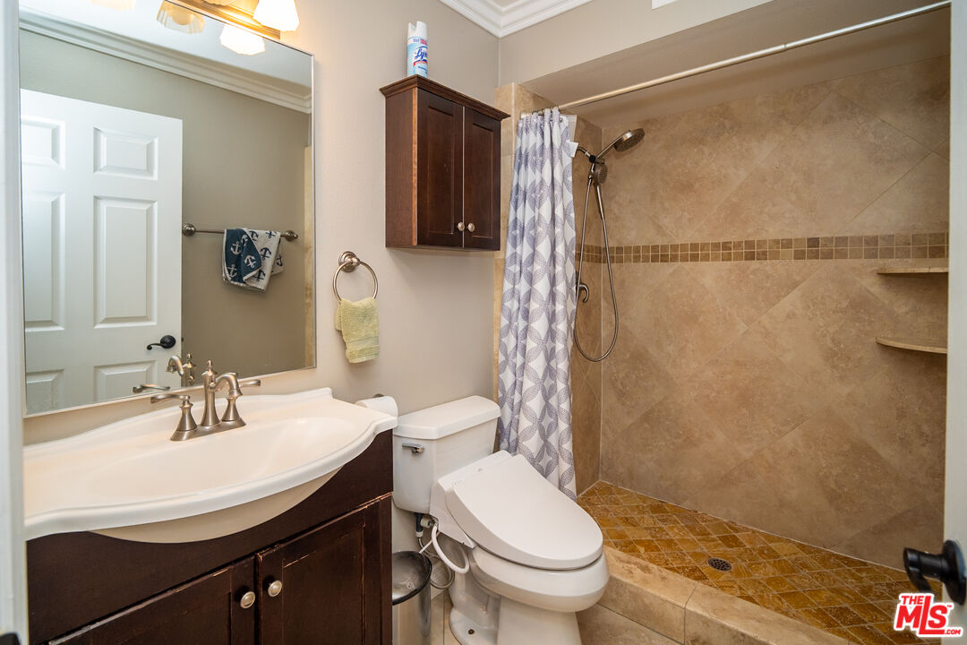 879 Shadowgrove Street Brea, CA 92821 - Photo 16 of 37 a bathroom with a sink toilet and shower