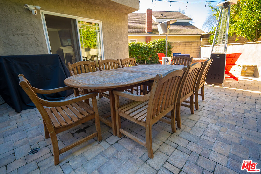 879 Shadowgrove Street Brea, CA 92821 - Photo 31 of 37 a view of a patio with table and chairs with wooden floor and fence