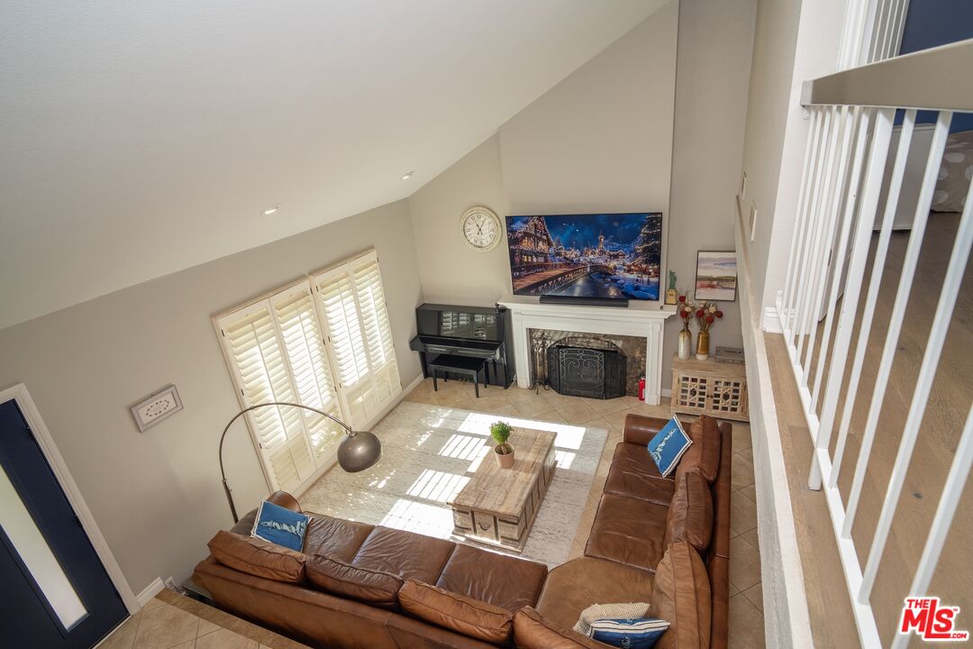 879 Shadowgrove Street Brea, CA 92821 - Photo 7 of 37 a living room with furniture a fireplace and a flat screen tv