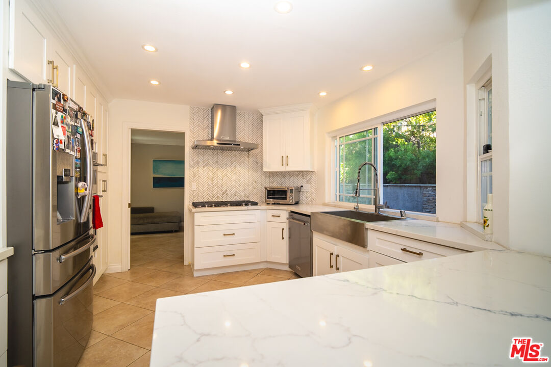 879 Shadowgrove Street Brea, CA 92821 - Photo 9 of 37 a kitchen with a refrigerator and a sink