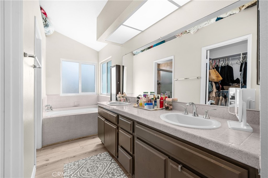 19465 Kinnow Lane Riverside, CA 92508 - Photo 26 of 61 a bathroom with a granite countertop sink mirror and bathtub