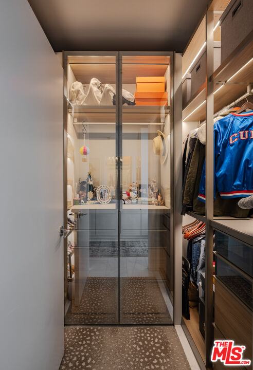 9000 West 3rd Street, Unit 103 Los Angeles, CA 90048 - Photo 13 of 27 a view of walk in closet with clothes and shoes